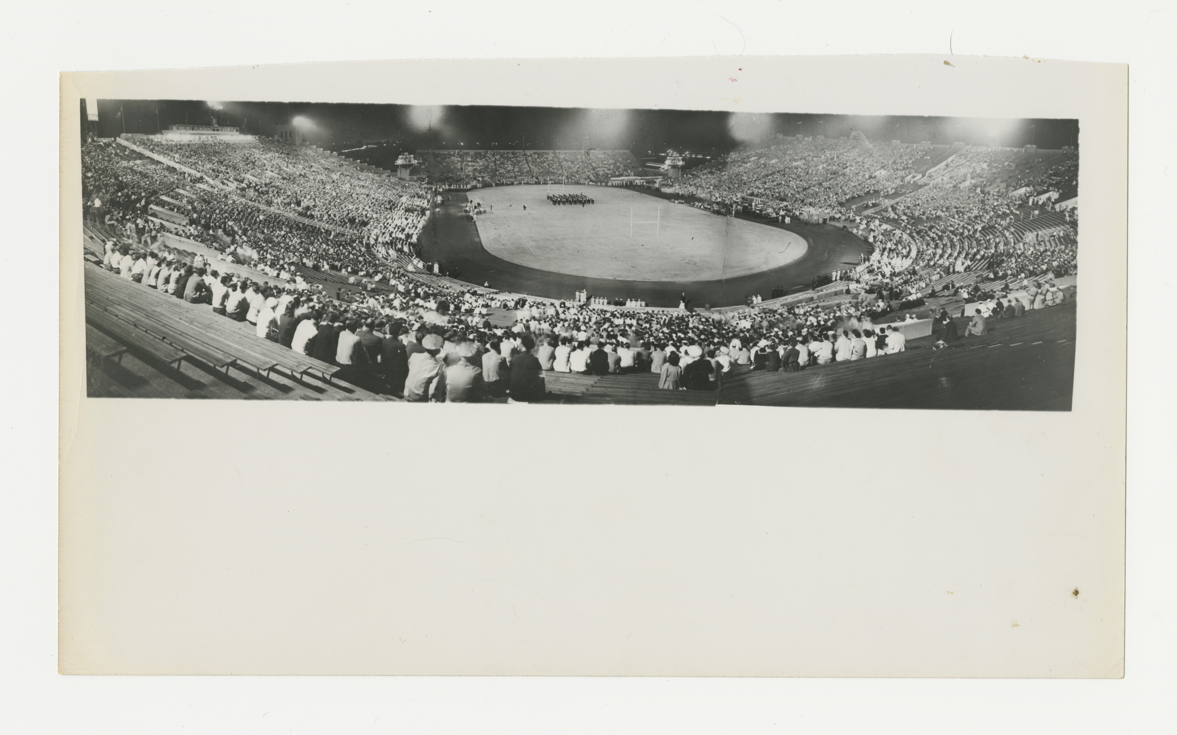 A multitude of veterans join civilians to watch a football game 