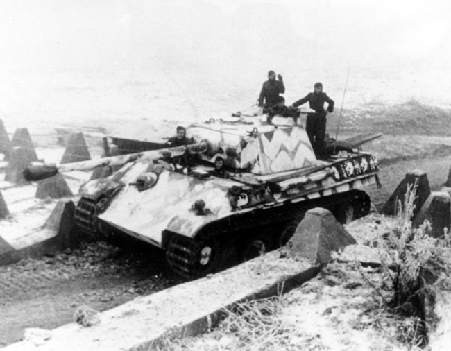 A German Panther tank is passing anti-tank obstacles of the Westwall 