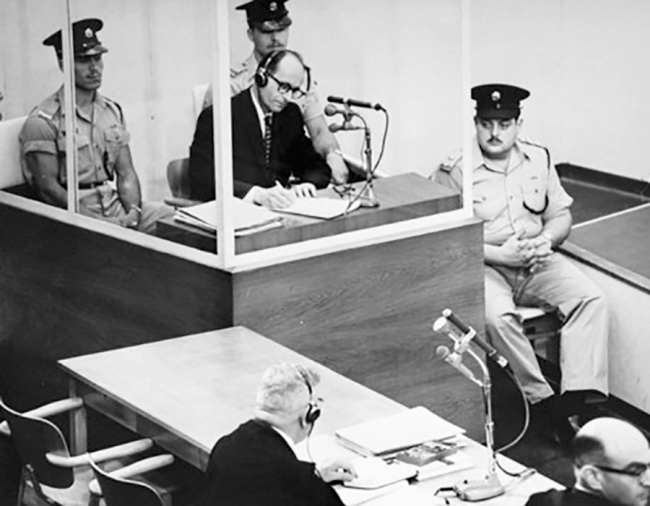 Adolf Eichmann taking notes during his trial