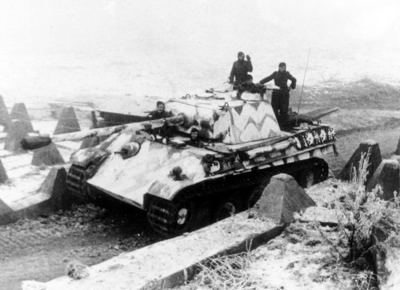A German Panther tank is passing anti-tank obstacles of the Westwall 