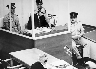Adolf Eichmann taking notes during his trial
